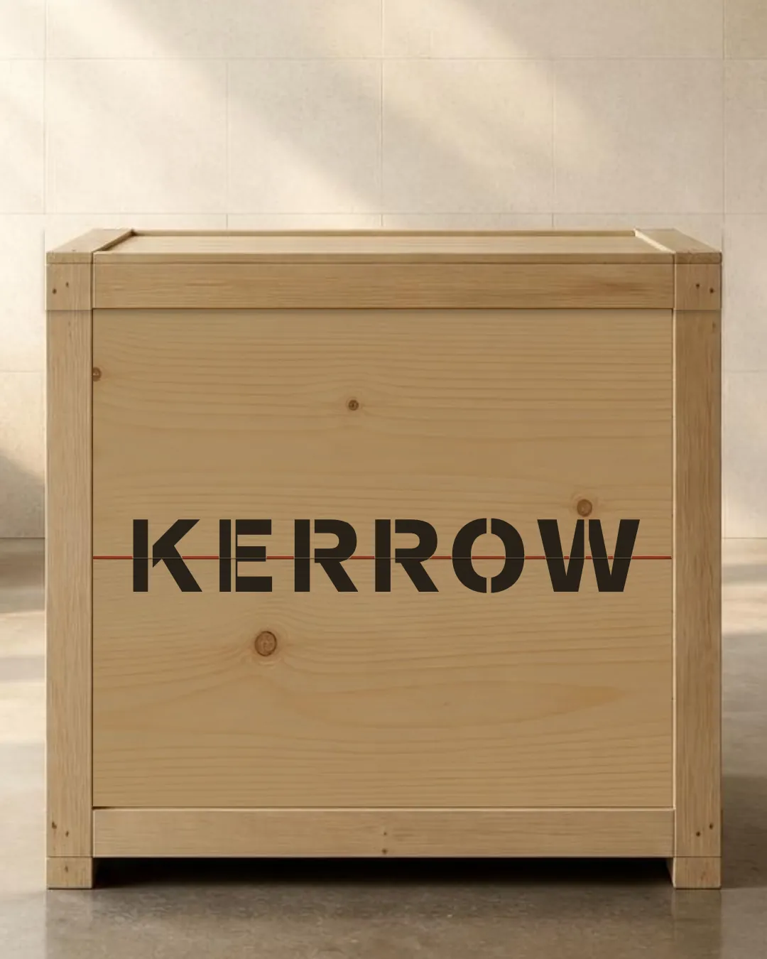 A pine crate with KERROW stencilled across two boards, with a hairline of red in the seam between them.