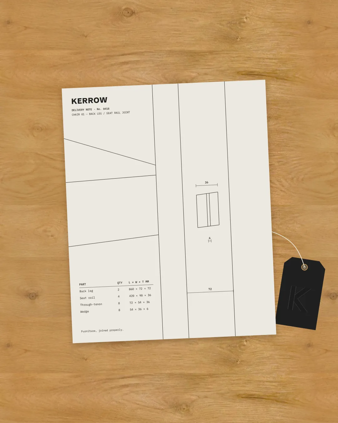 A Kerrow delivery note with a technical drawing and cut list on an oak desk, beside a graphite swing tag with an embossed K.