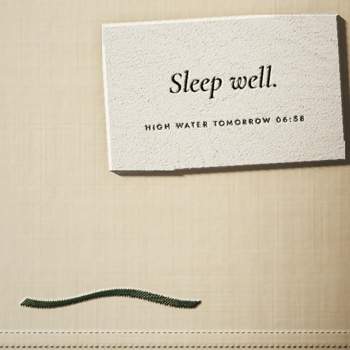 The pillow card, Sleep well, HIGH WATER TOMORROW 06:58, above a tide line embroidered in green thread.