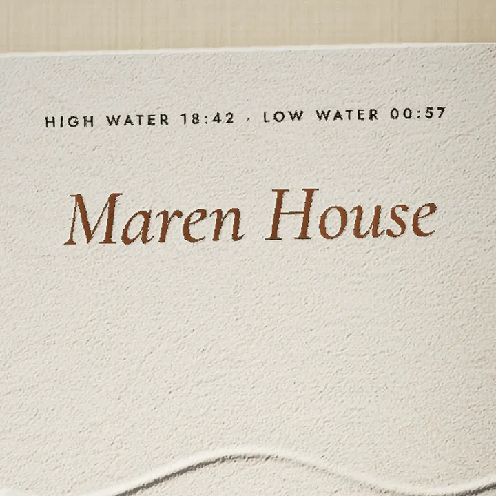 The top of the menu: HIGH WATER 18:42 · LOW WATER 00:57 above Maren House in copper foil.