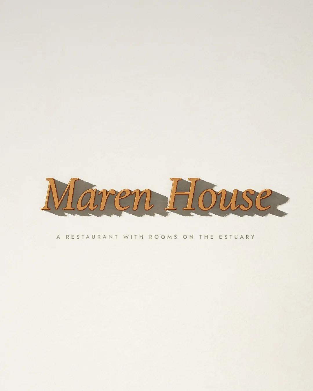 Maren House in copper letters standing off a lime-washed wall, casting long shadows.